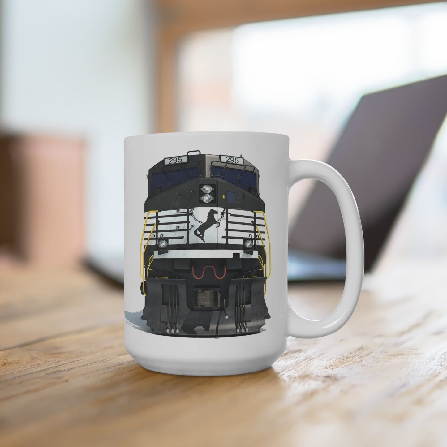 15 oz white ceramic coffee mug featuring a detailed front view of a black Norfolk Southern diesel locomotive with the horse logo and yellow handrails.