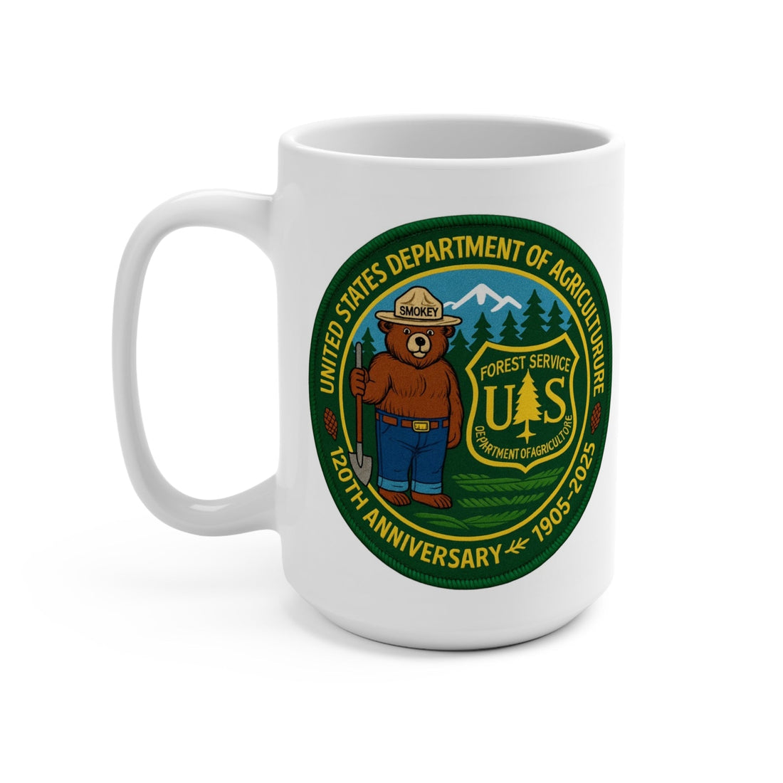 White ceramic Smokey Bear 120th Anniversary US Forest Service mug with full wrap-around design featuring Smokey Bear in ranger hat, shovel, pine trees, mountains, and 1905-2025 text