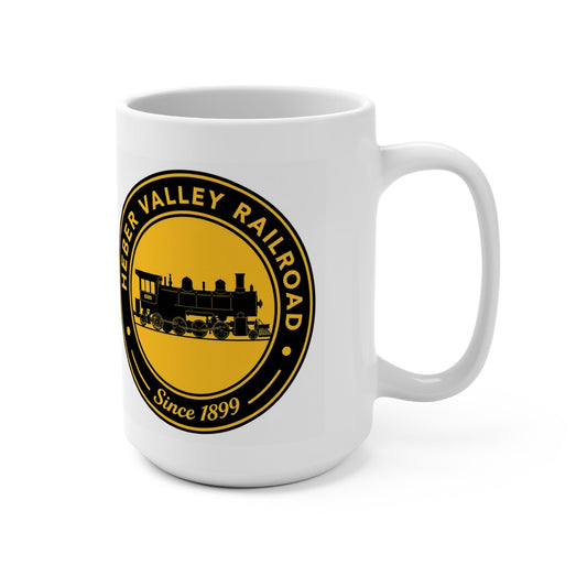 Right-handle view of a white 15 oz Heber Valley Railroad mug featuring a black-and-gold vintage steam train logo and “Since 1899.