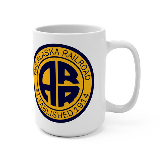 Angled view of a white ceramic Alaska Railroad mug showing the iconic AR emblem in navy blue and vibrant gold on a clean white background