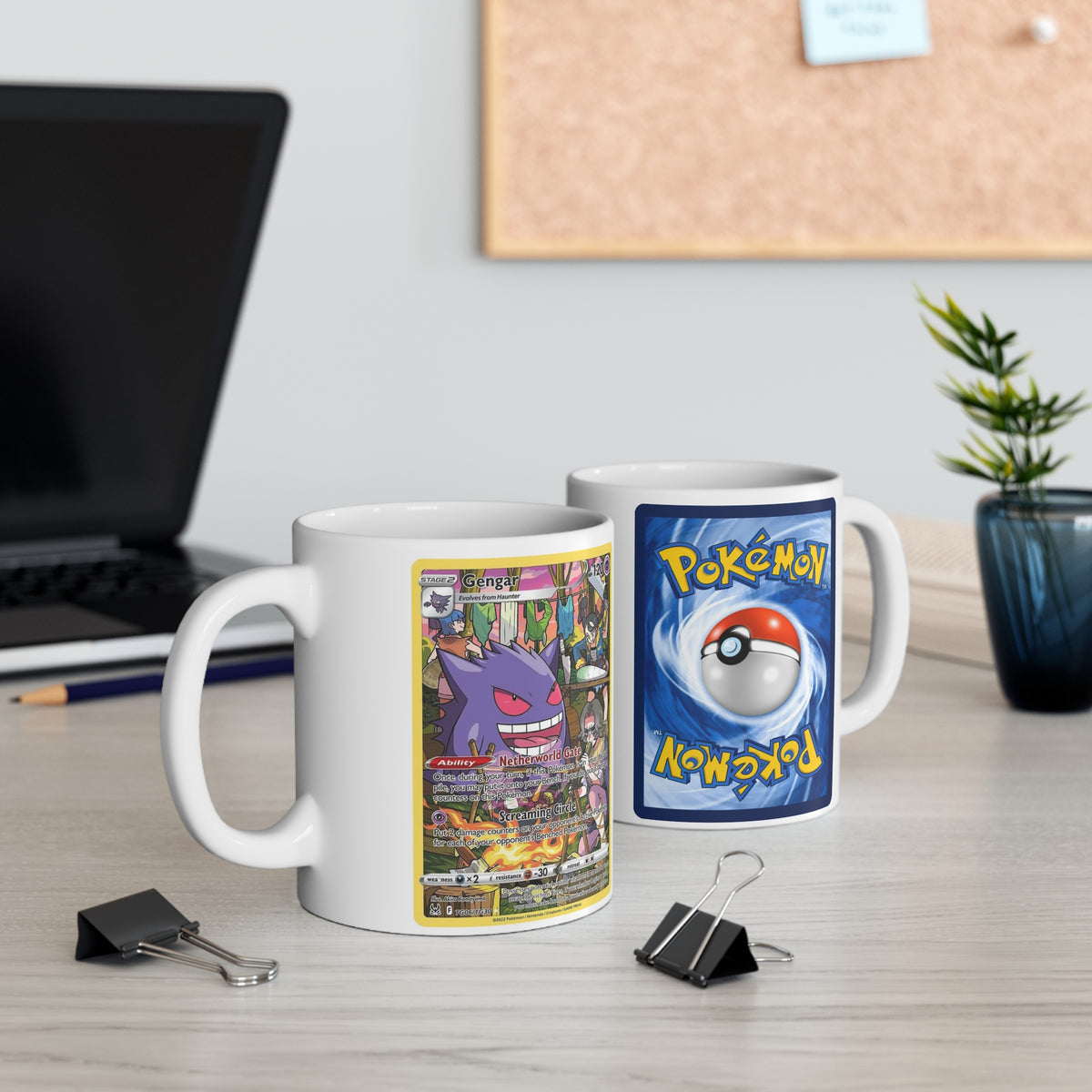 White ceramic mug with blue Pokémon card-back artwork, a central Poké Ball, and the handle on the right.