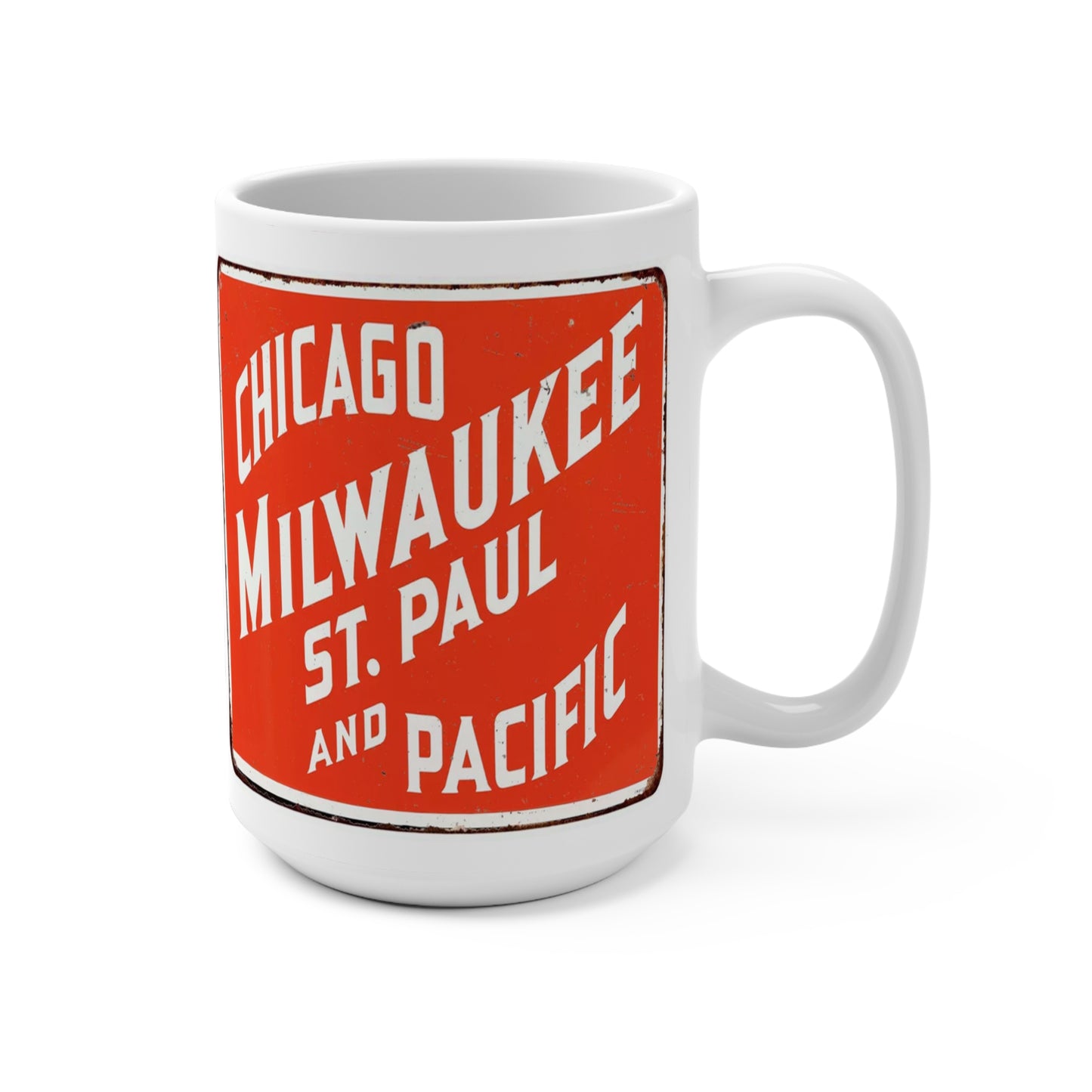 A white ceramic mug with orange and black text design featuring the words 'CHICAGO MILWAUKEE ST. PAUL AND PACIFIC' and a graphical element resembling train tracks.