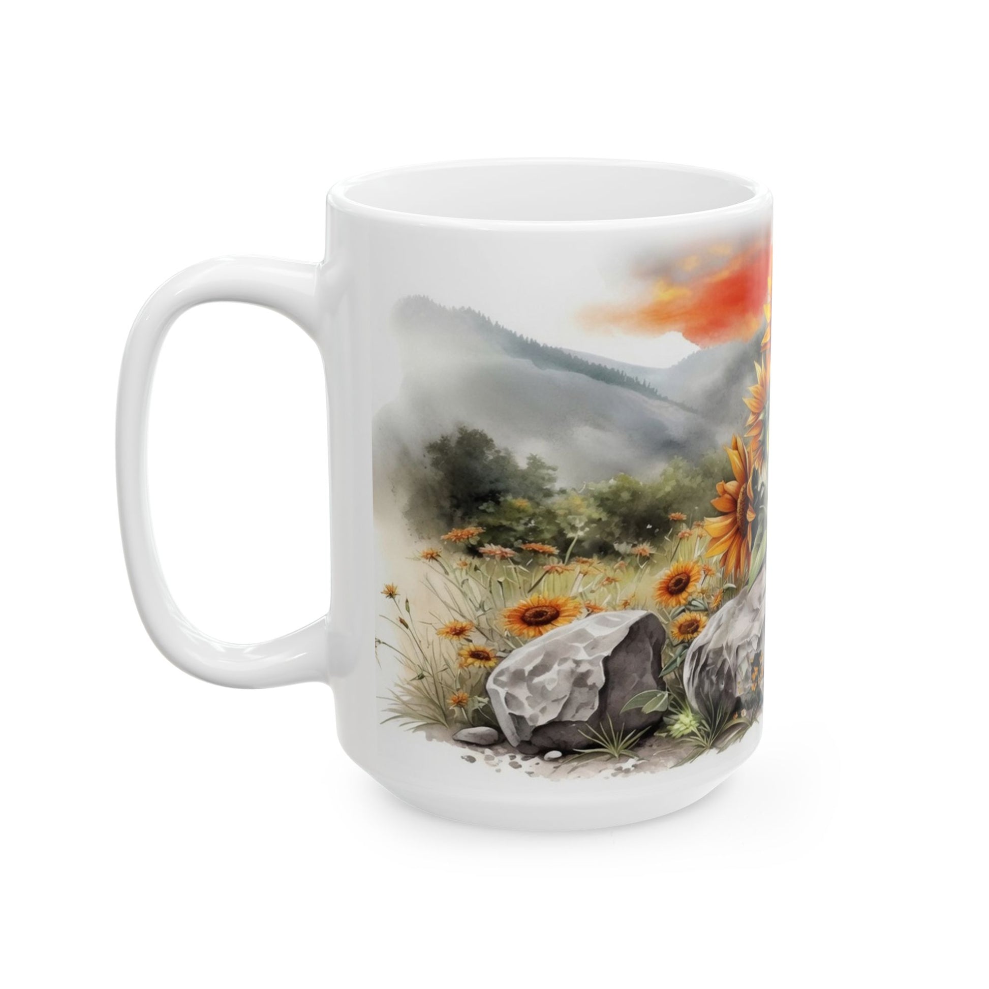 White ceramic coffee mug featuring sunflowers, wildflowers, rocks, mountains, and meadow landscape design